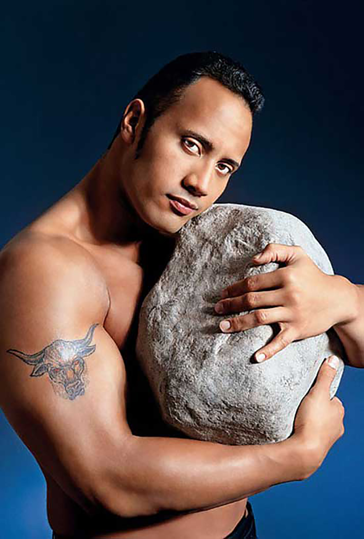 The Rock holding a rock in the late 1990s.