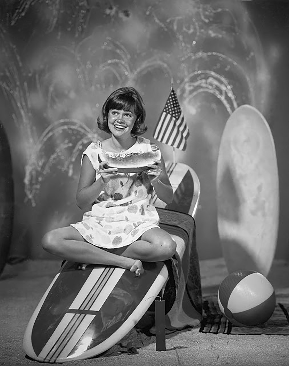 A promotional picture of Sally Field eating watermelon on a surfboard for the show Gidget in 1965.