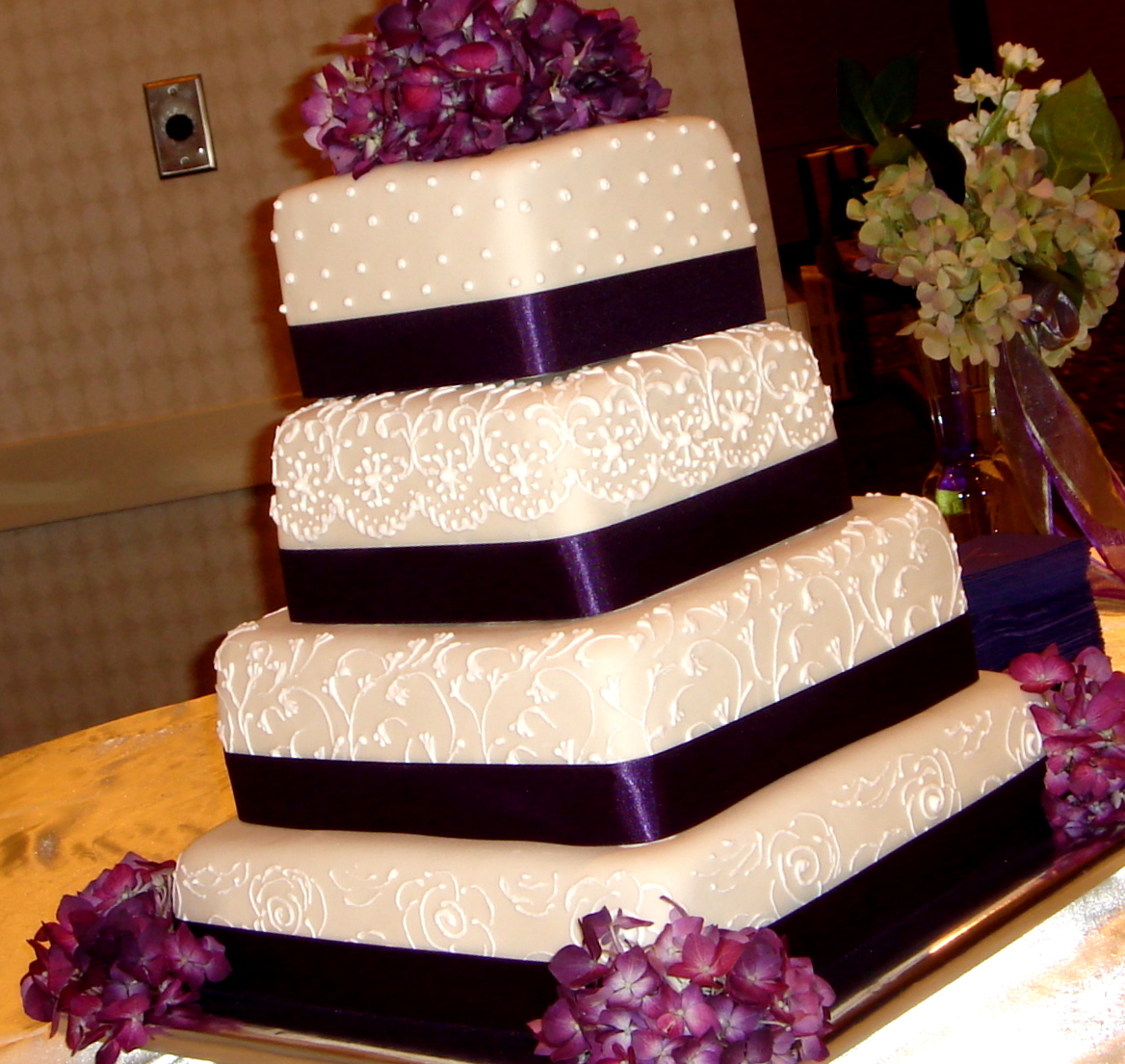 wedding cake with purple ribbons