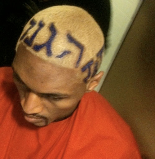 Ron Artest, writes defense in his hair in 3 different languages