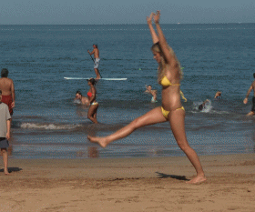 gifs - woman does a cartwheel in a bikini by the beach