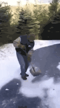 gifs - man tries to shovel snow and slides across the ice