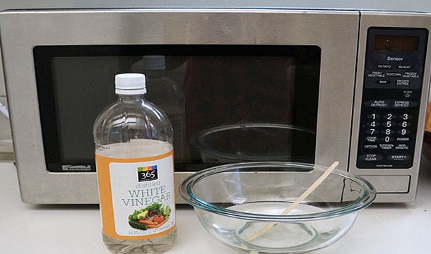 Place a bowl of water containing a bit of vinegar in the microwave for about 5 minutes. The inside of the microwave will get nice and steamy and all the food stains will come right off with a few good wipes.