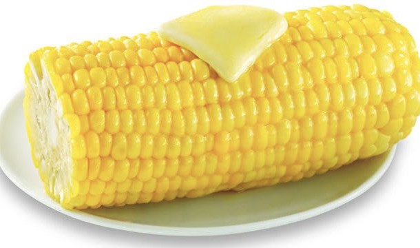 Put it in the microwave husk and all. After several minutes the husk will slide right off and the corn will be sweet and tender!