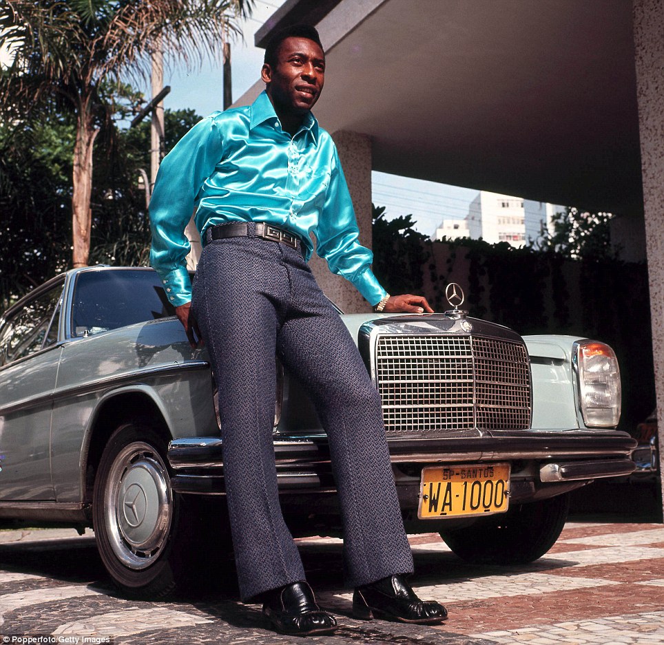 Pro soccer player Pele posing in front of his Mercedes in 1970.