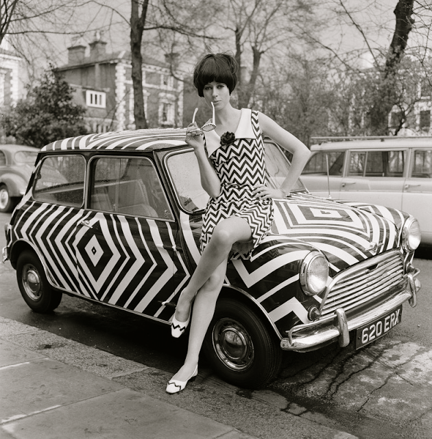 Girl sitting on an 1966 pimped up ride.