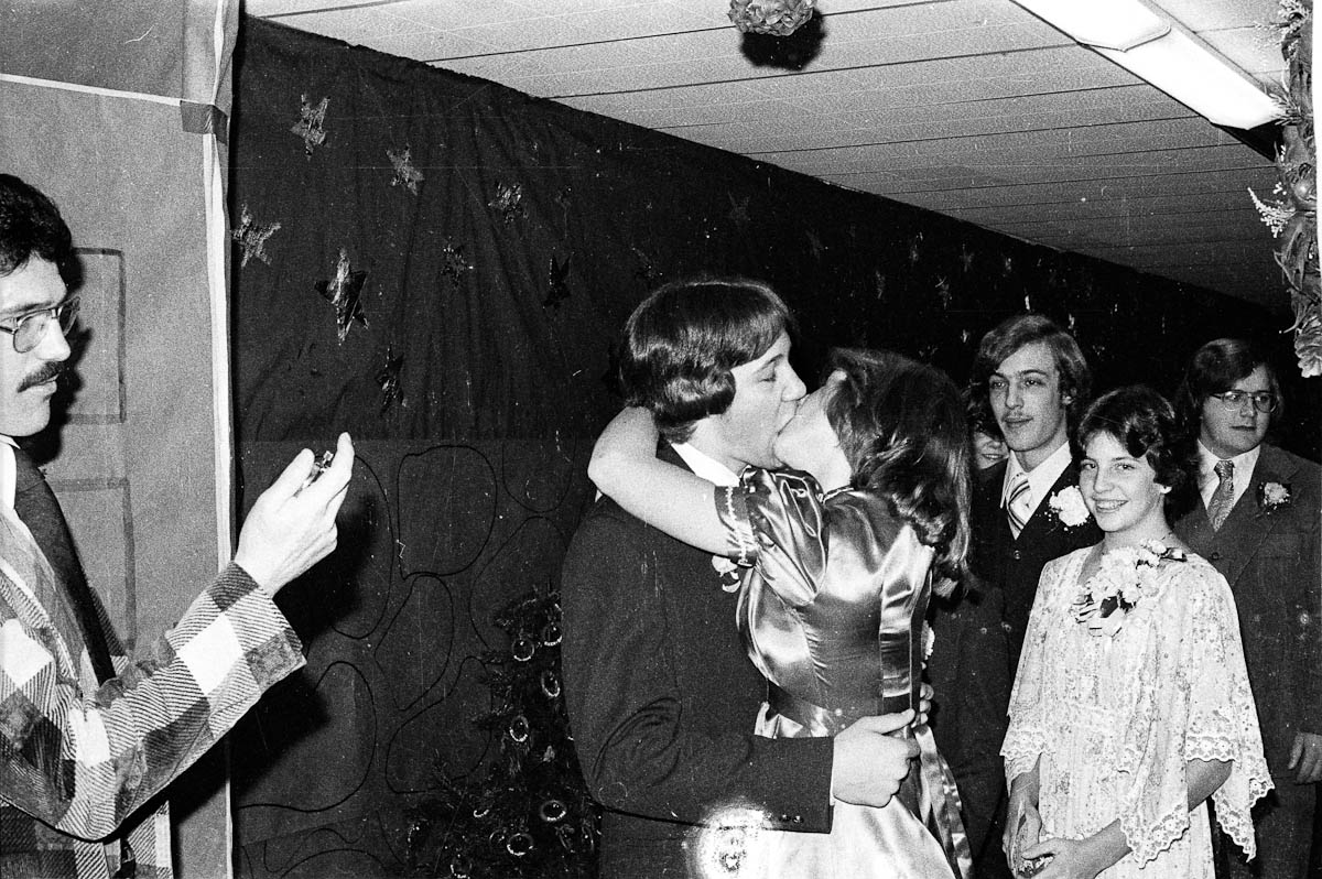 Teacher timing kisses at the prom (1978).