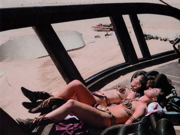 Carrie Fisher sunbathing with her stunt double on the set of Return of the Jedi, 1982.