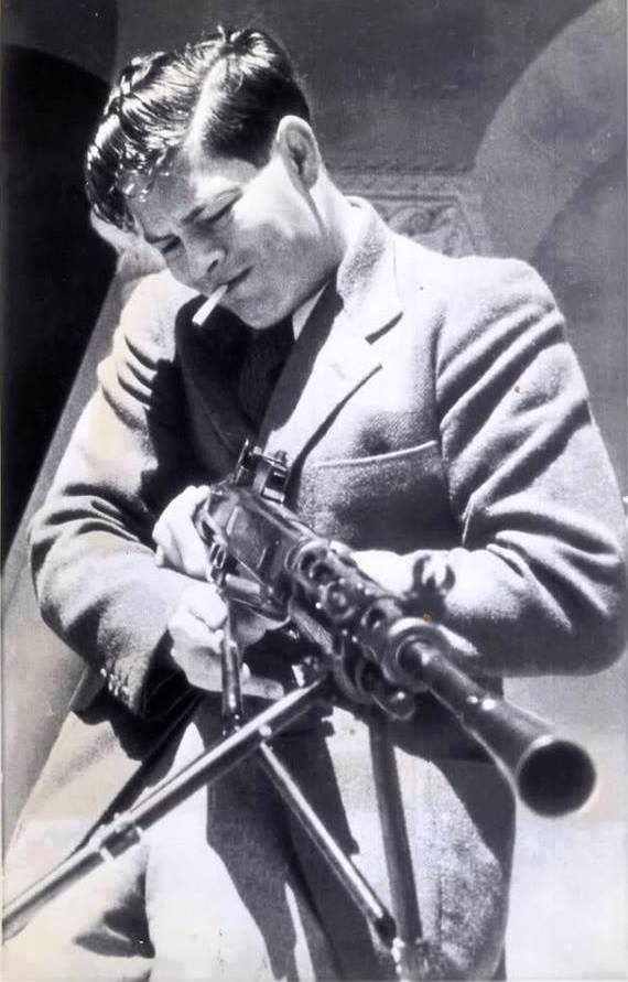 King Michael I of Romania at the age of 21 testing a Russian machine gun in Sevastopol, 1943.
