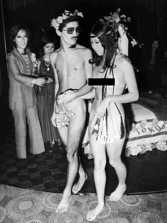 Two Japanese fashion designers photographed at their nude wedding in a Tokyo 

nightclub, November 1970.