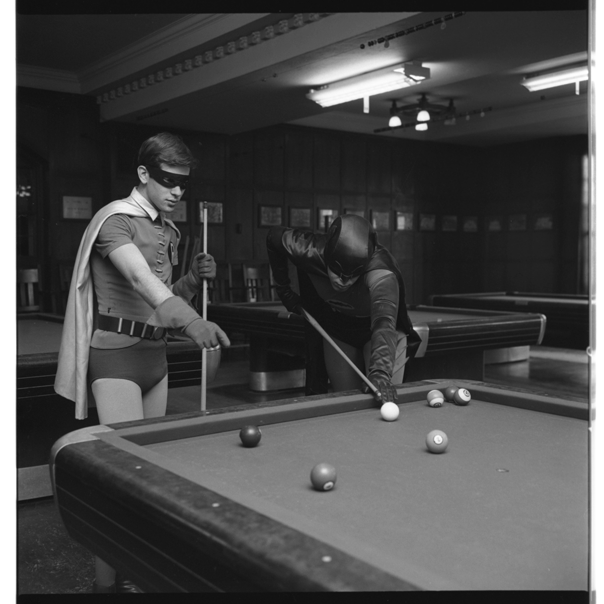 Students dressed as Batman and Robin playing pool at the Michigan Union 

(1966).