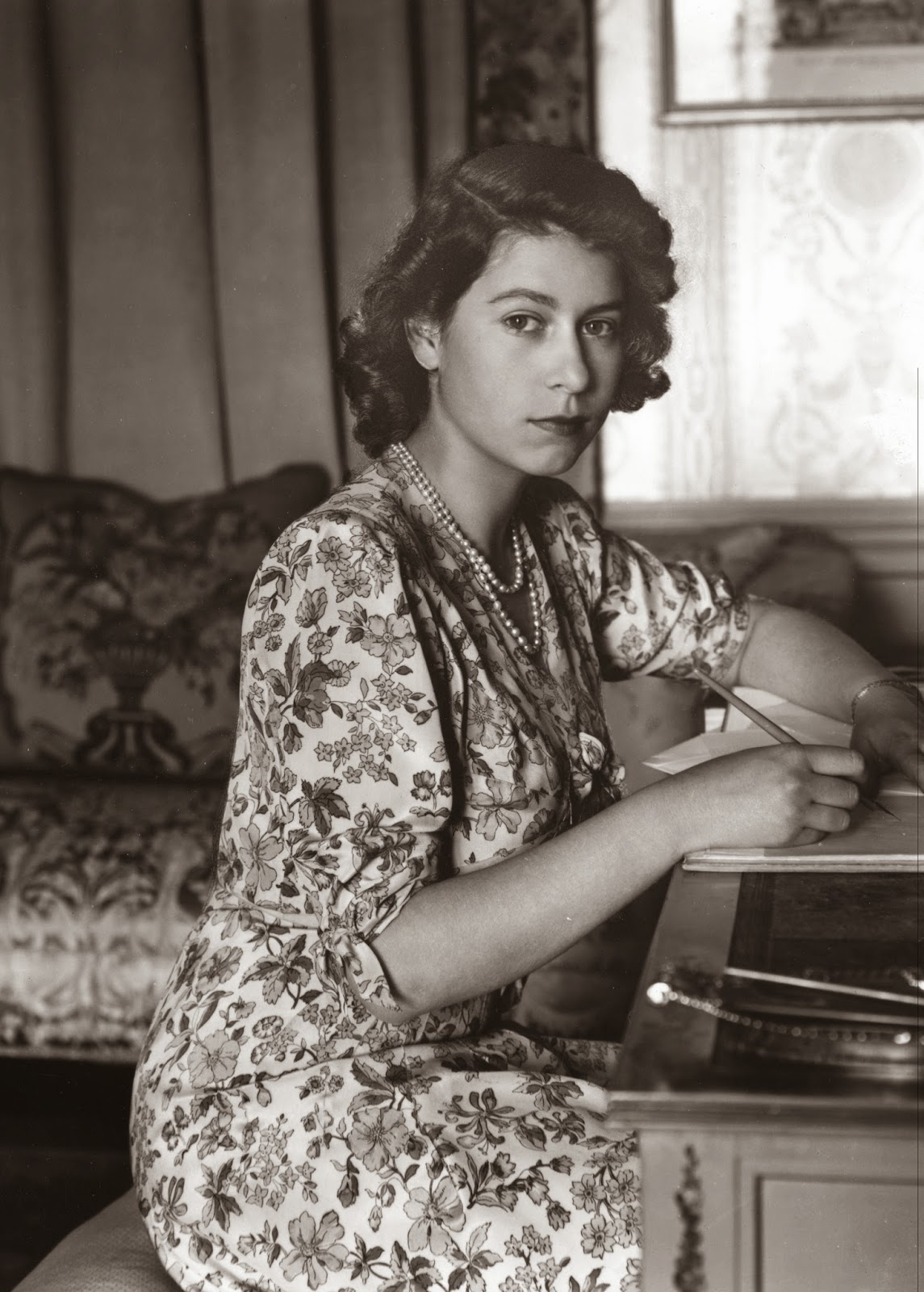 Queen (then Princess) Elizabeth, photographed while writing at her desk 

in 1944.
