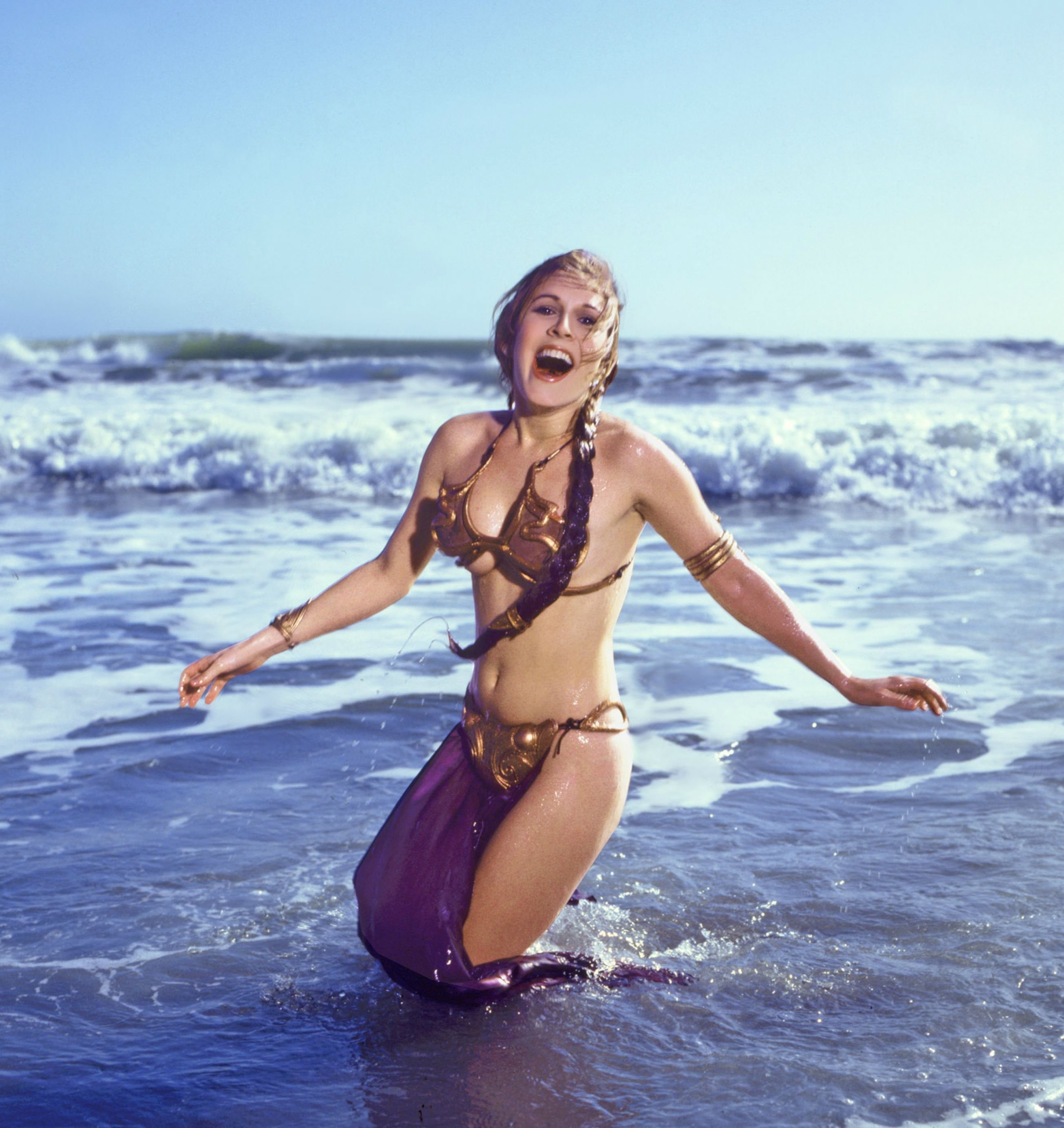 Carrie Fisher wearing metal bikini at the beach, 1983.