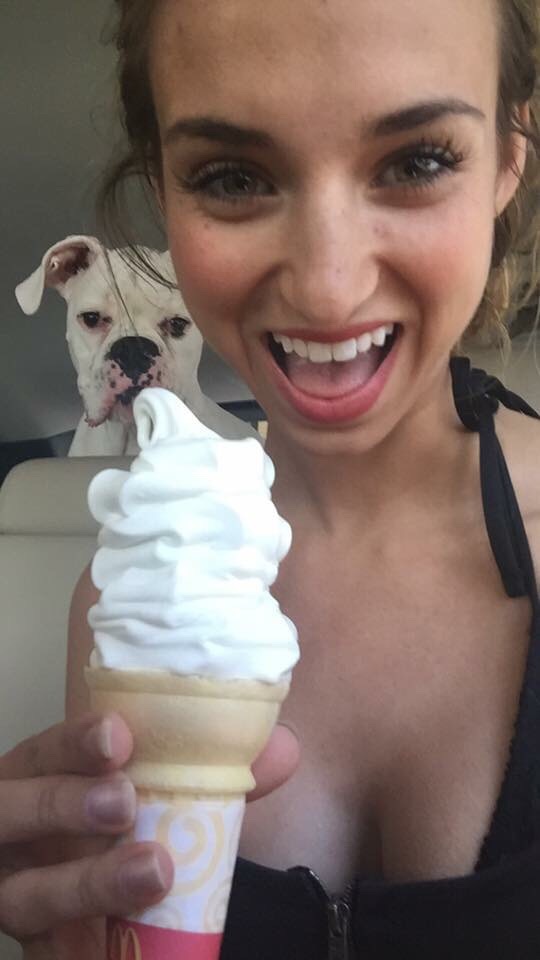 girl with an ice cream cone and a dog