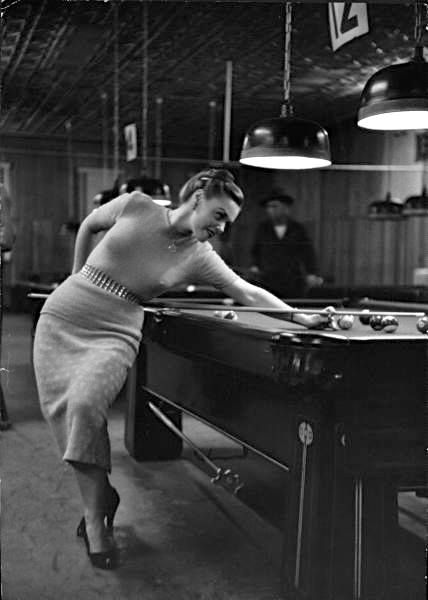 Woman playing pool in the 50's.