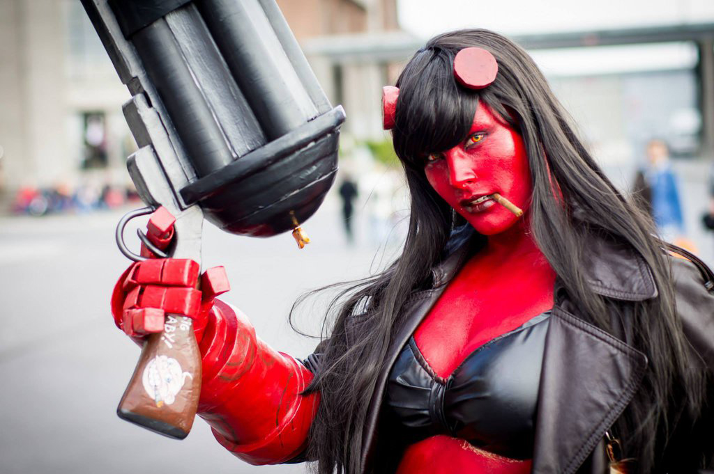 A girl cosplaying as Hellboy.