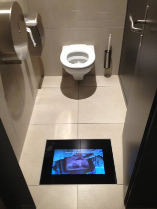 This movie theater has screens in the bathrooms so you don't miss any 

of the action in the movie.