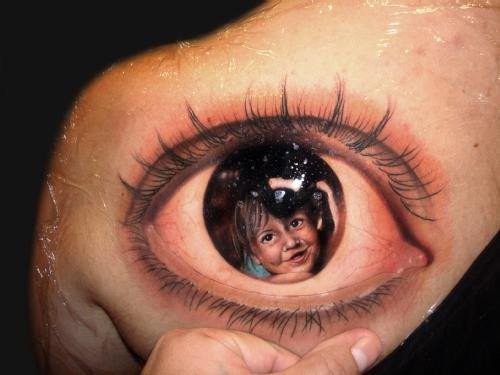 child in eye tattoo