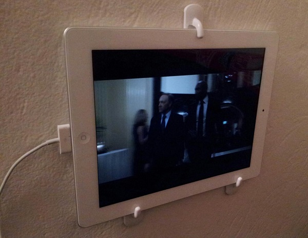Use wall hooks to attach iPad to the wall.