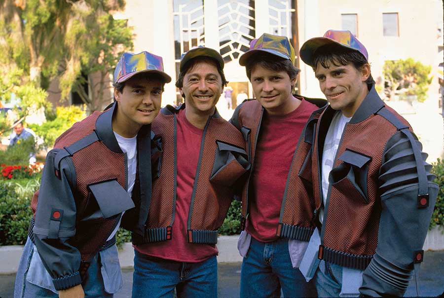 Michael J. Fox with his photo double Kevin Holloway, stand-in Robert Bennett and stunt double Charlie Croughwell on the set of Back to the Future Part II, 1989.