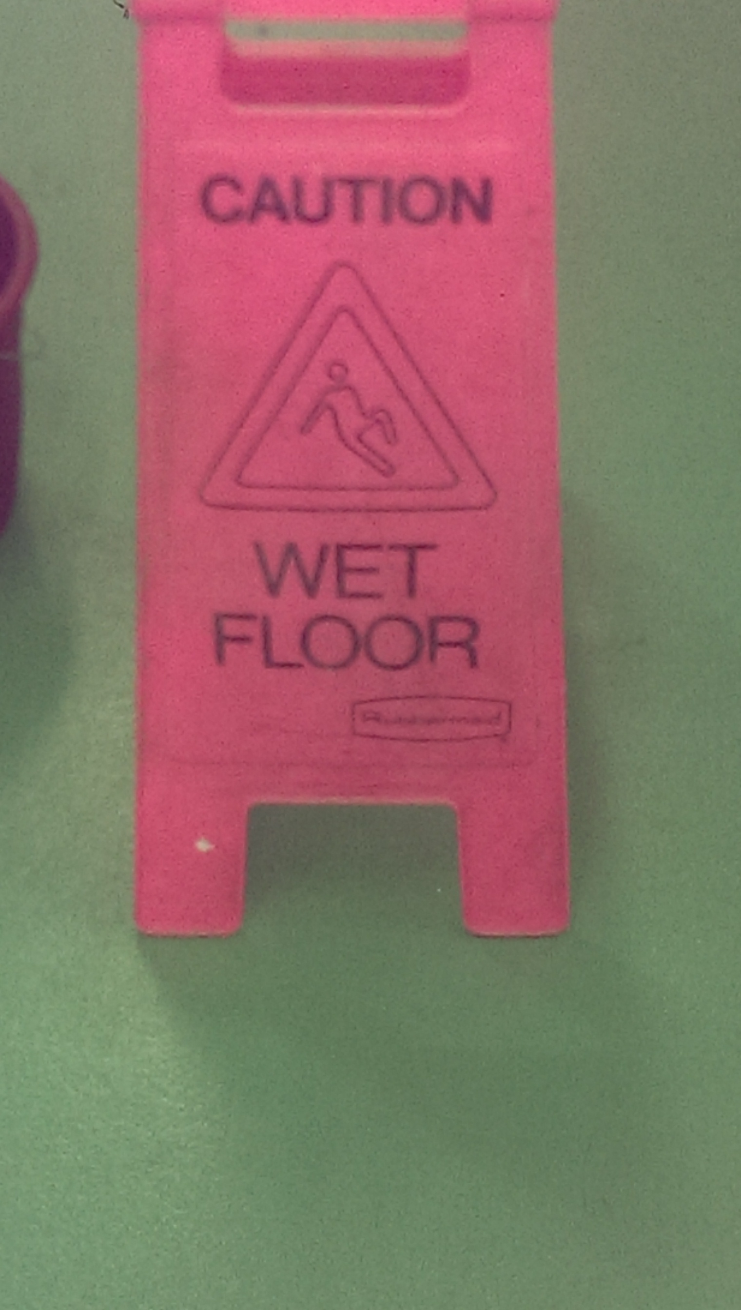 The guy on this wet floor sign looks like he's trying to seduce.