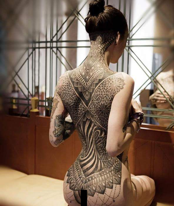 This girl's tattoo is a one piece that goes from head, through neck, 

covers the back and ends at her buttocks.