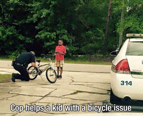 Police officer - 314 Cop helps a kid with a bicycle issue