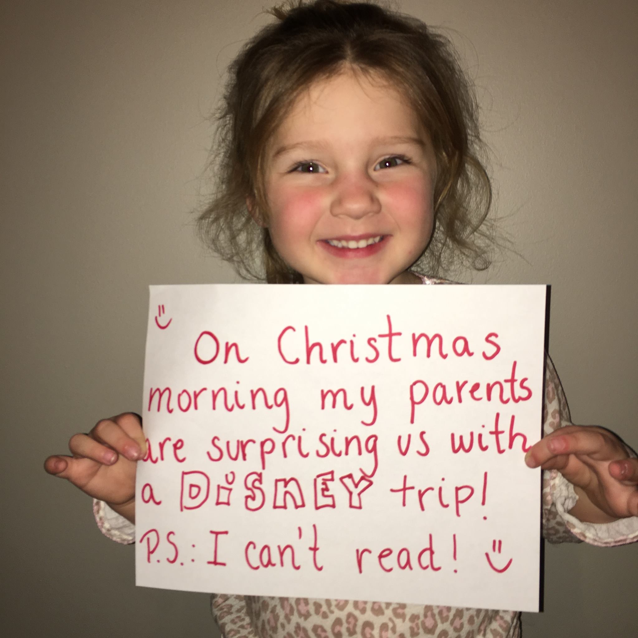 smile - On Christmas, morning my parents Care surprising us with a Disney trip! P.S. I can't read!