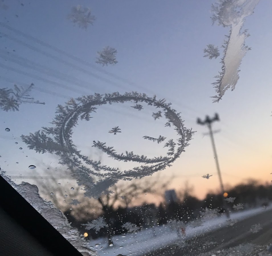 The frost on this windshield made a winking smiley face.