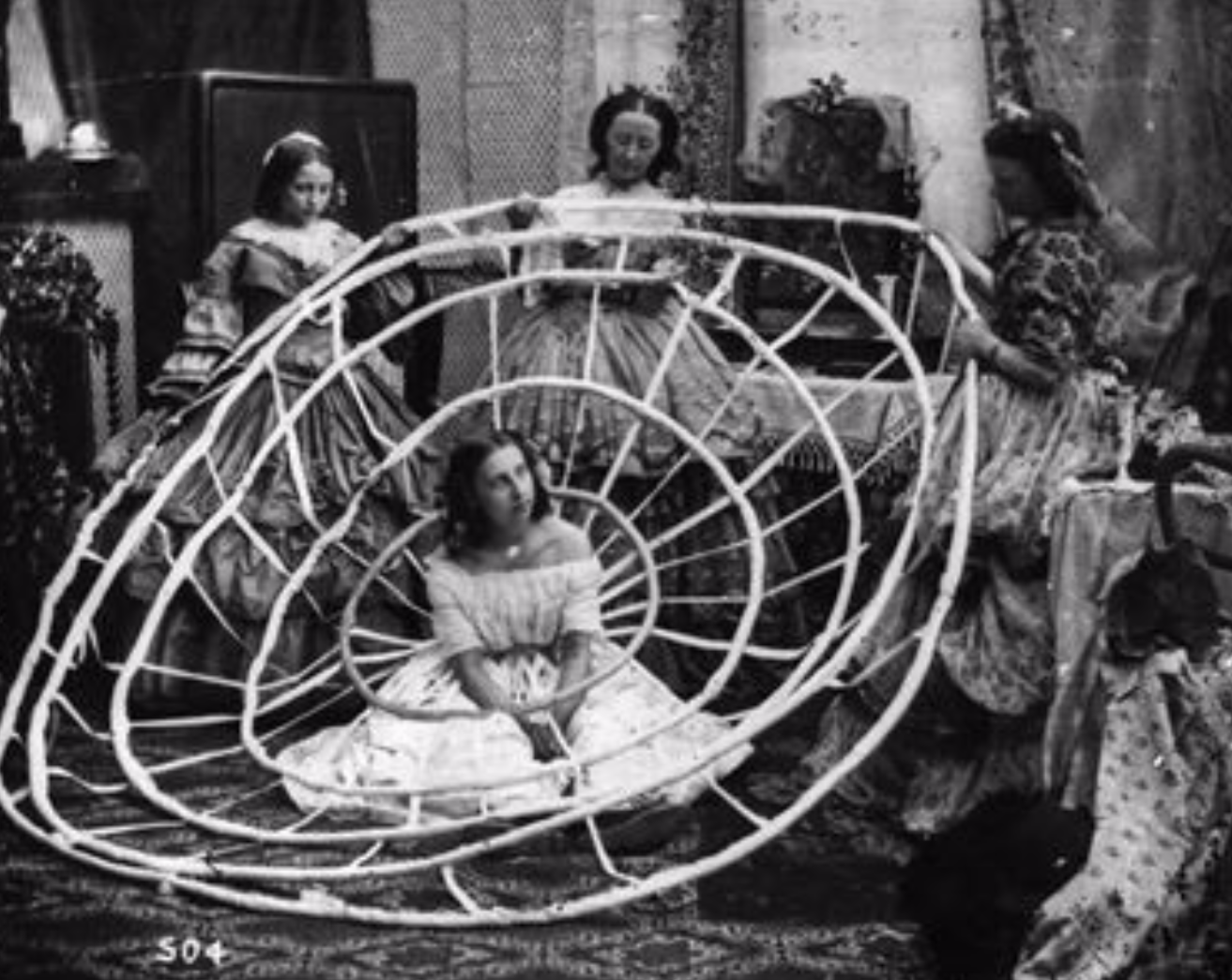 A woman waits for the hoops of her crinoline to be finished in a London dress 

shop in 1860.
