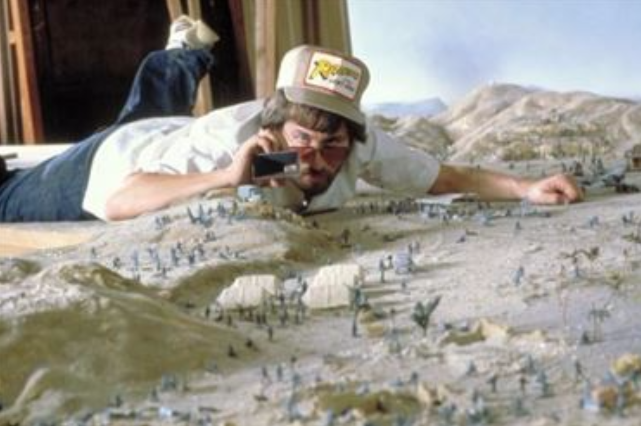 Steven Spielberg taking photos of some of the set pieces that were made as 

miniatures for the first Indiana Jones movie Raiders of the Lost Ark.