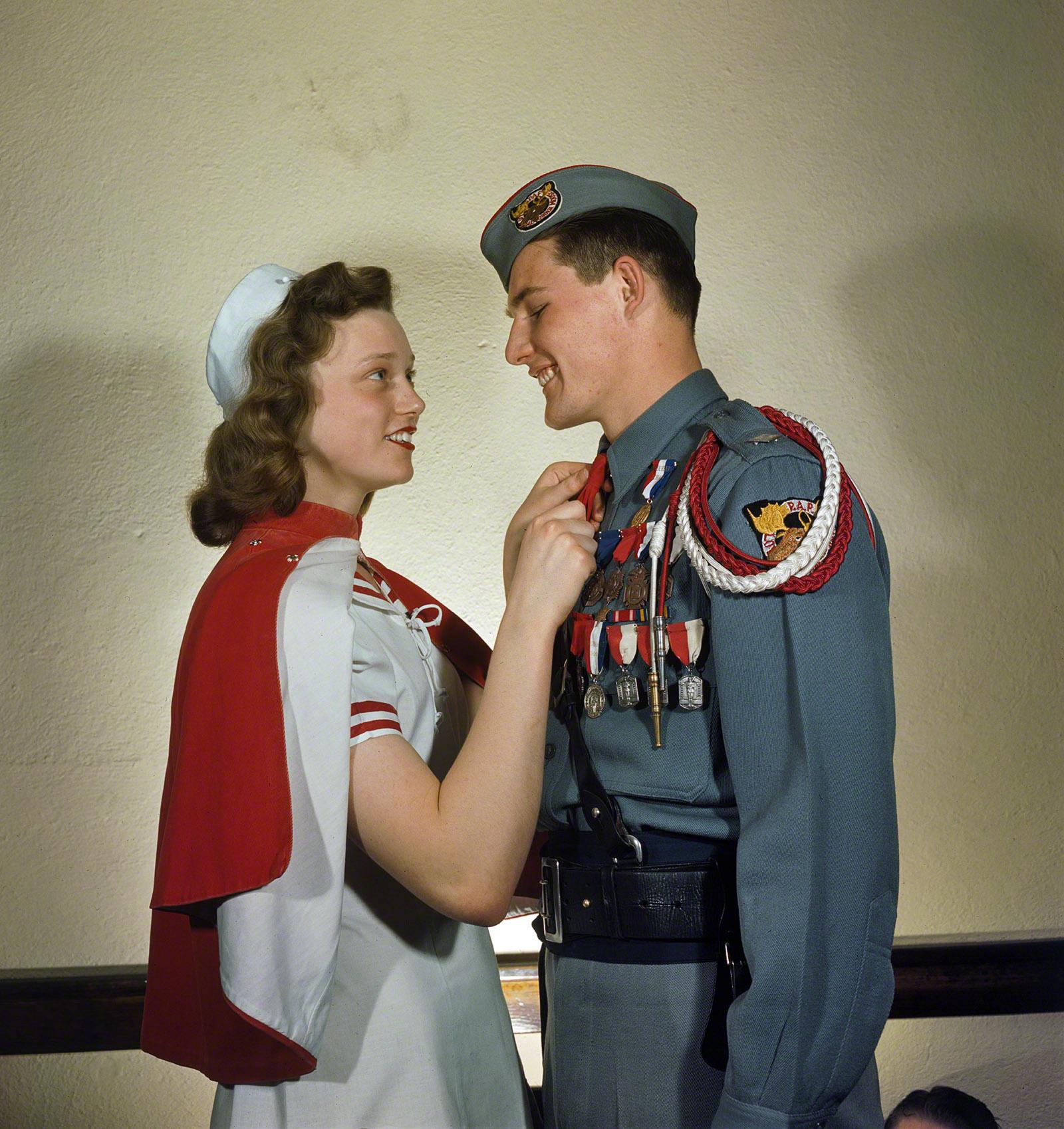 Two high school students in their cadet corps uniforms at a dance, 1948.