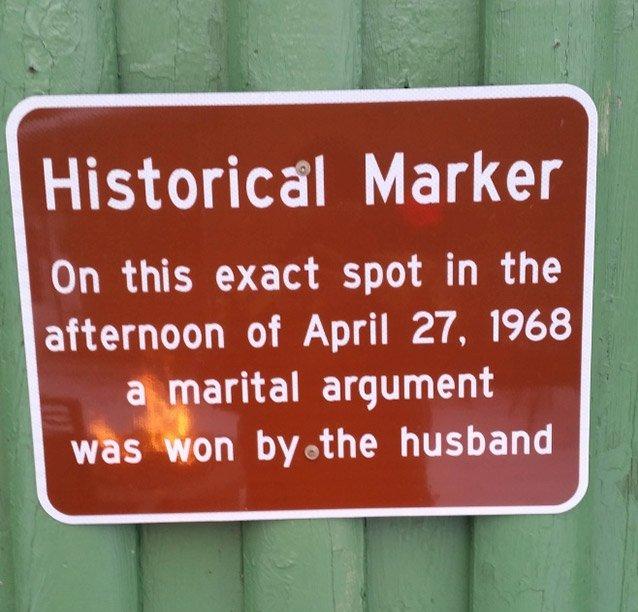 street sign - Historical Marker On this exact spot in the afternoon of a marital argument was won by the husband