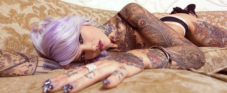 woman with tattoos and purple hair