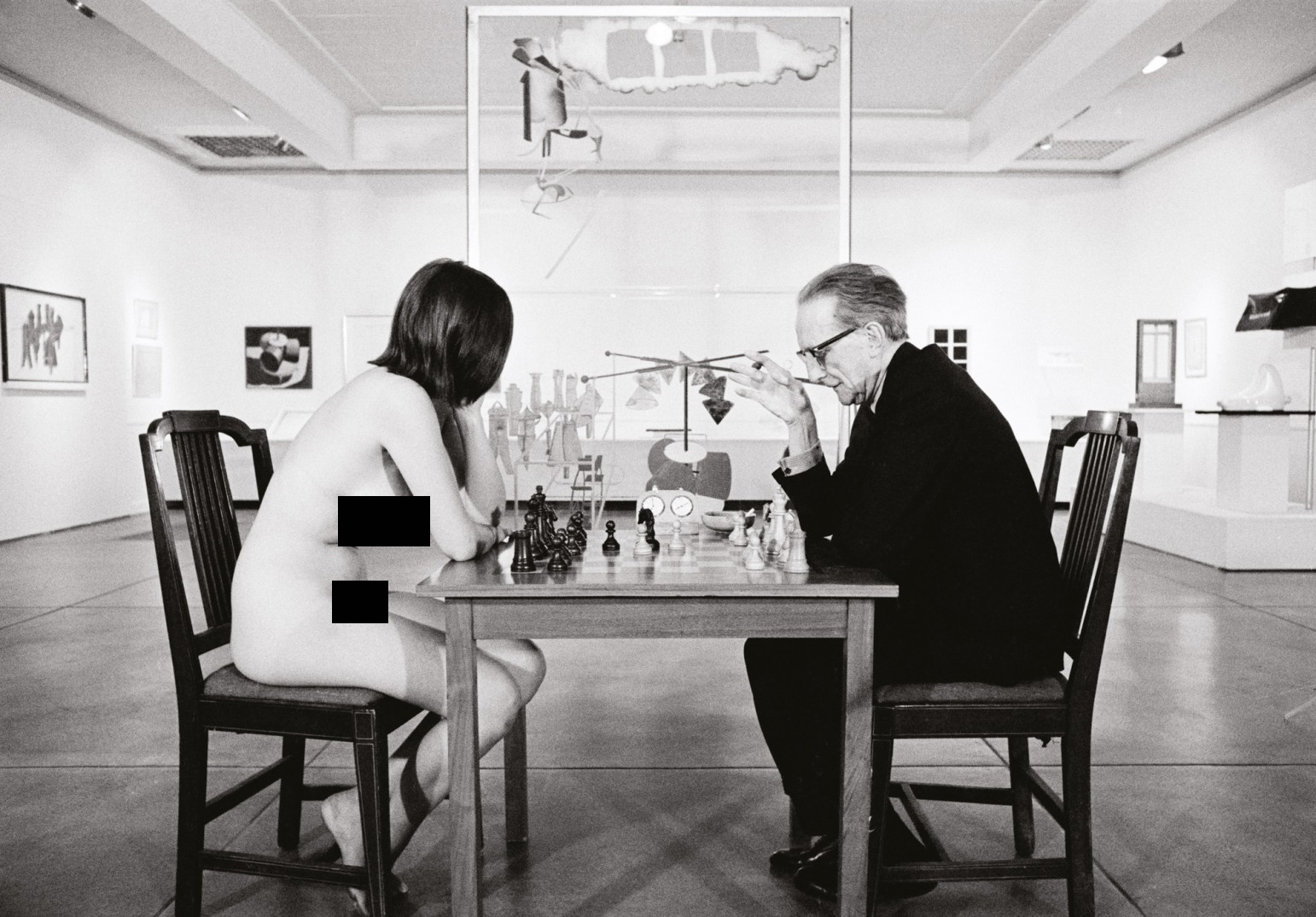 Marcel Duchamp playing chess with naked Eve Babitz, 1963.