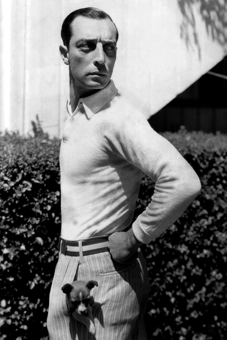 Buster Keaton with a puppy in his pocket, 1920s.