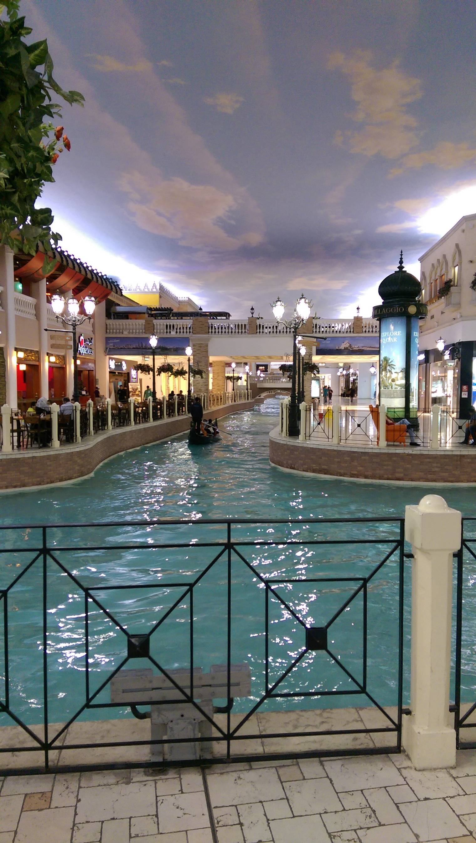 This mall has a river in the middle of it and the ceiling is painted like the 

sky.