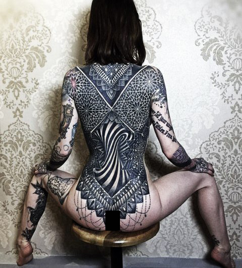 Her back
 is the canvas for a symmetrical masterpiece of a tattoo.
