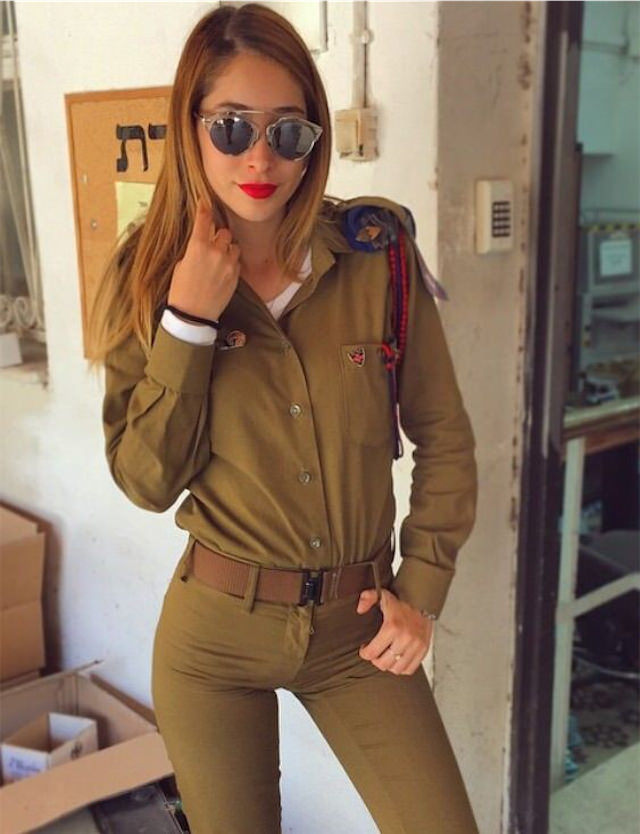 Kim Mellibovsky in IDF uniform and red lipstick with sunglassses.