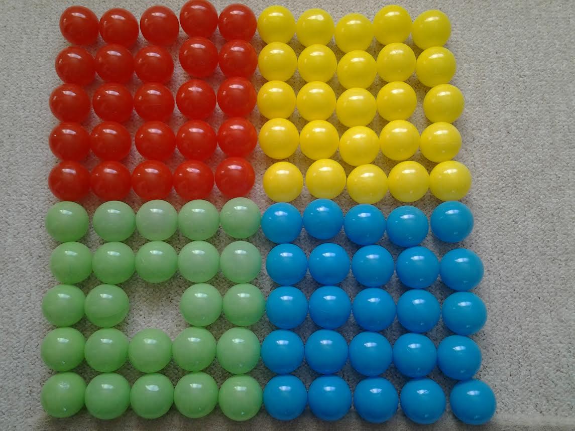 Jelly beans organized by color and just one green one is missing