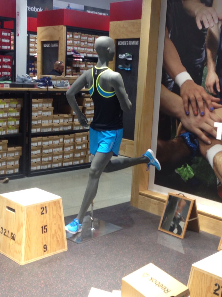 Mannequin that is running with his torso on backwards.