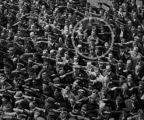 A lone man refusing to do the Nazi salute, 1936.