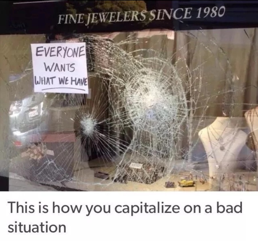 funny picture of a Jeweler with busted up windows and cheeky sign joking that everyone wants what we have