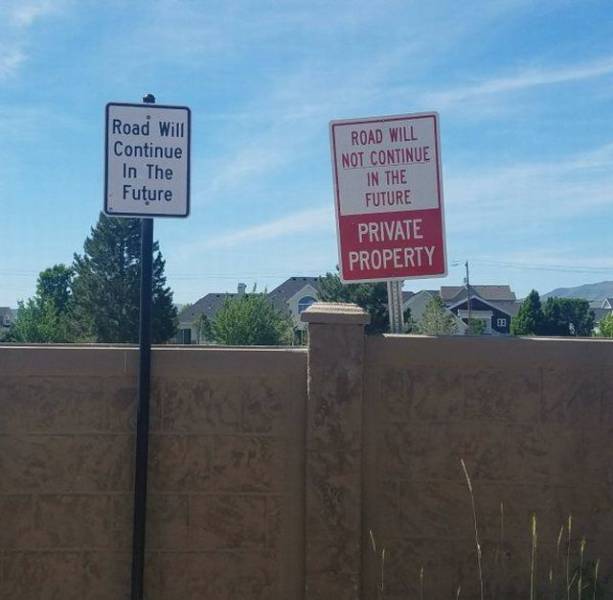 conflicting signs about a road that may or may not continue in the future