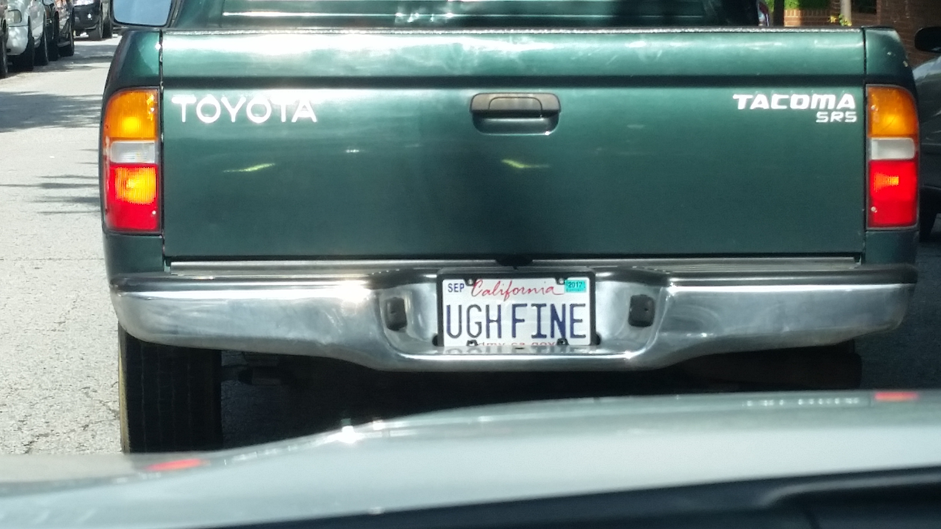 License plate of California that says Ugh fine