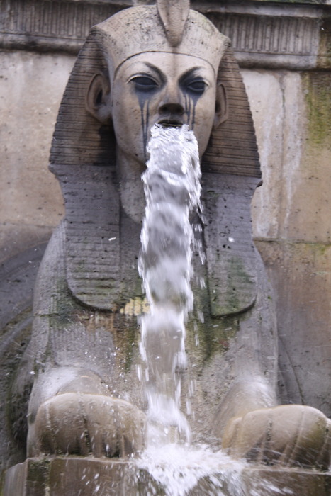 Water fountain that looks like vomiting Egyptian god.