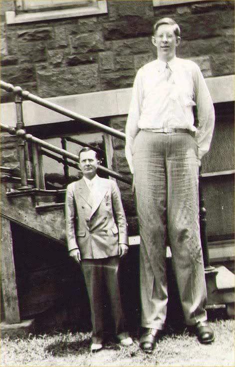 A 20 year old Robert Wadlow, the world's tallest Human Being, standing with his Father, 1938.