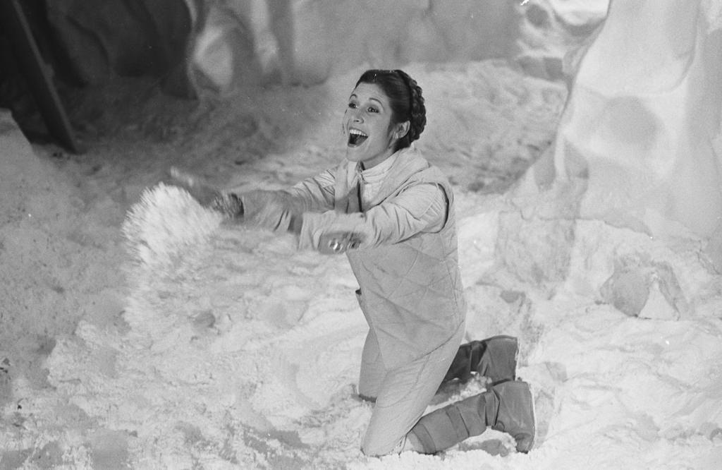Carrie Fisher playing with the snow and joking around on the set of Star Wars.