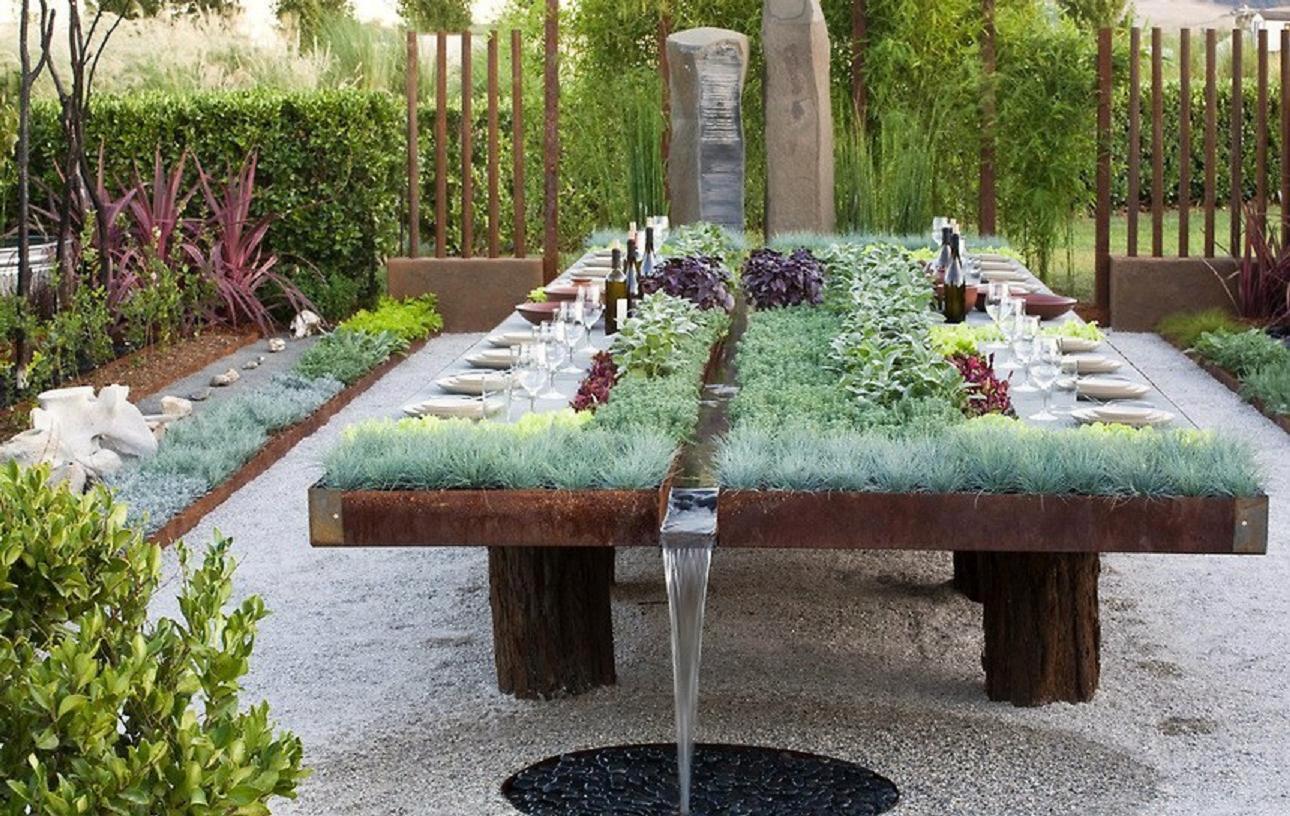 Awesome table in a garden from which the water falls from into it's place