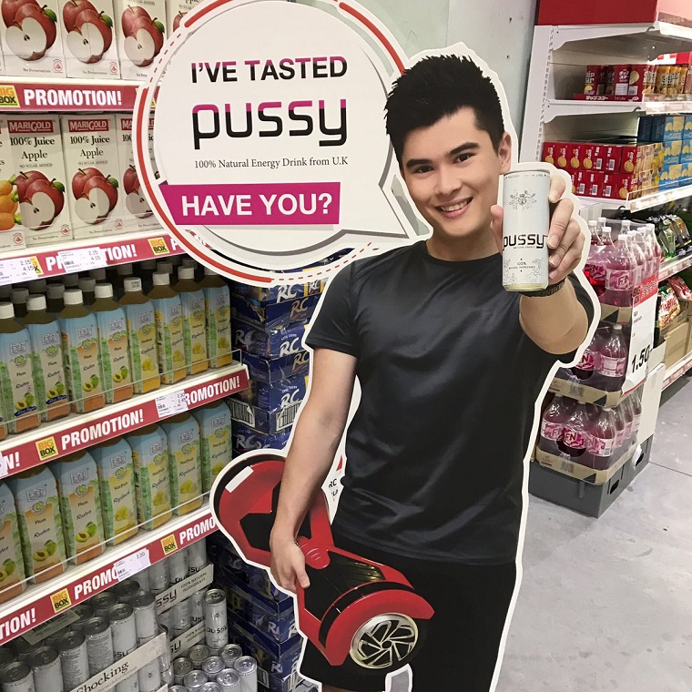 Cardboard cutout of a dude with a hoverboard and a drink called PUSSY that totally makes sense for him to be drinking.